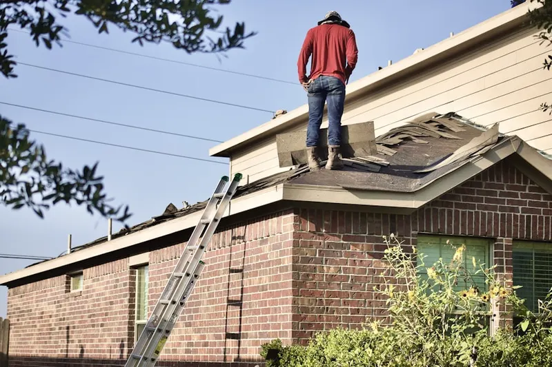 Professional roofer working on a residential roof in North Springs